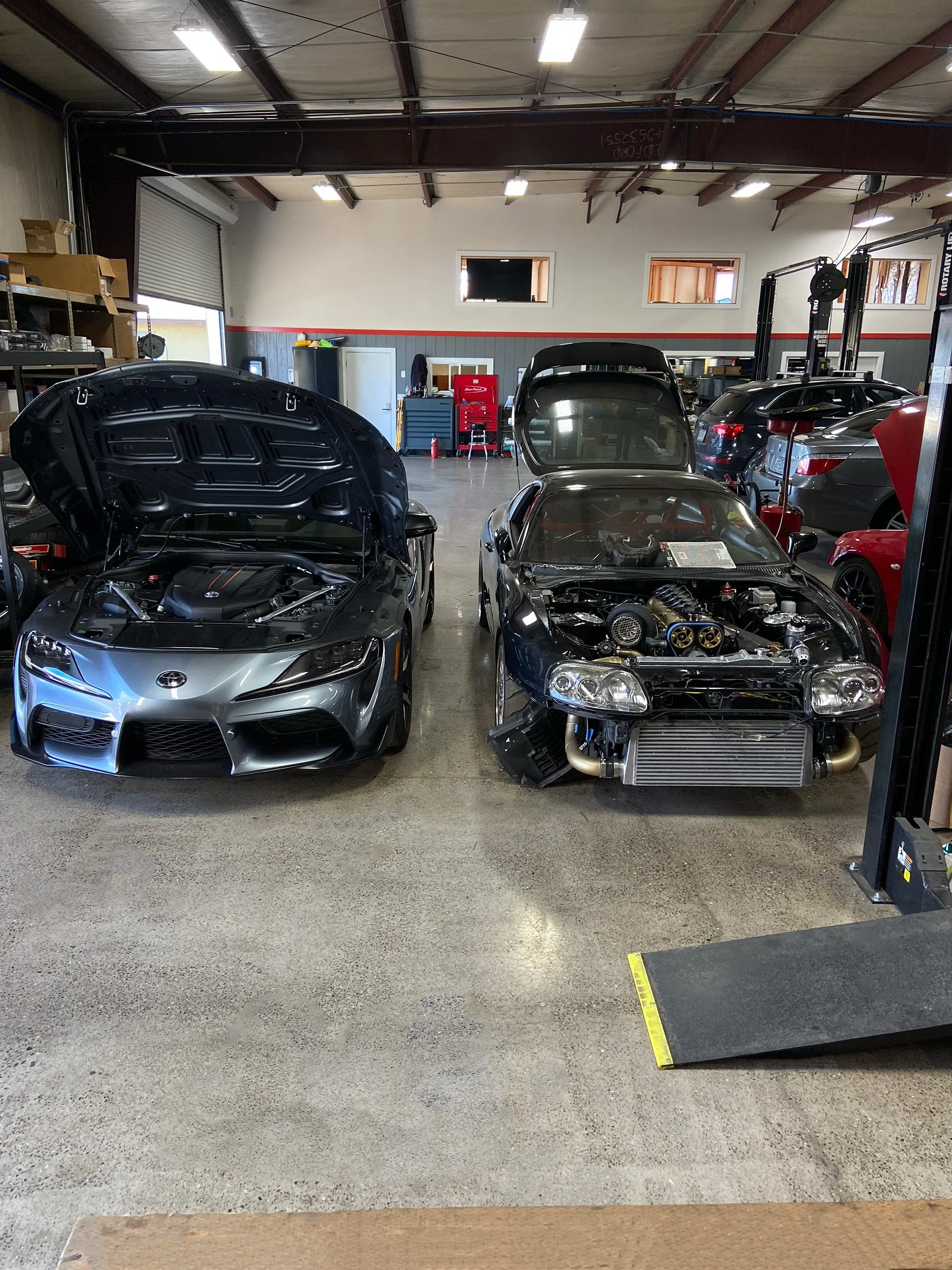 Two Toyota Supras in the shop for aftermarket parts installation